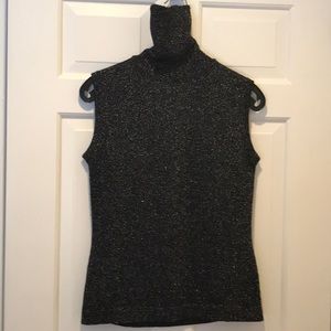 Sleeveless sweater with very high turtleneck